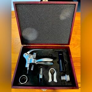 Wine bottle opener with accessories in wooden box